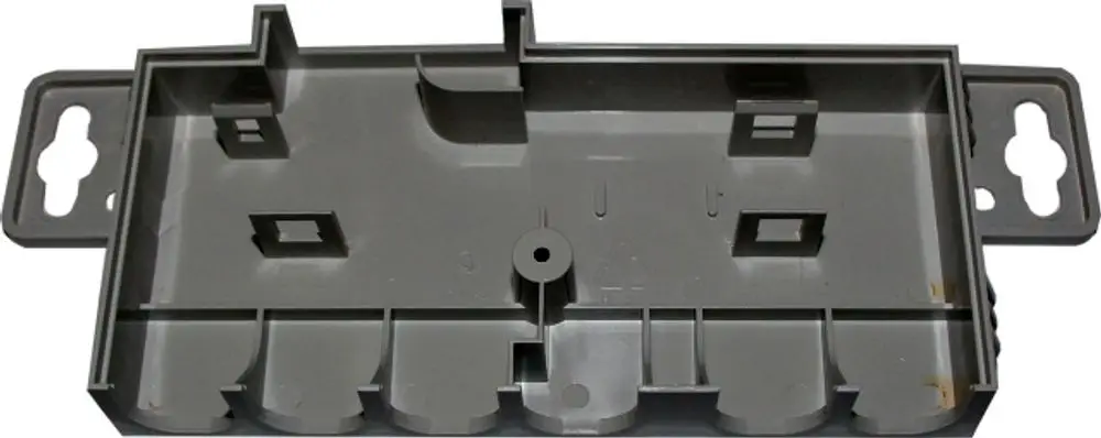 Grau Kunststoffgehäuse, innen mit verschiedenen Stecker- und Befestigungsmöglichkeiten, geeignet für die Verwendung in Verteilern oder Anschlusskästen, Marke Wolf.